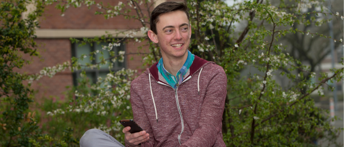 male student holding a cellphone