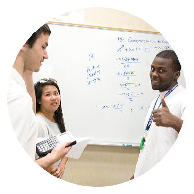 students in front of a math white board